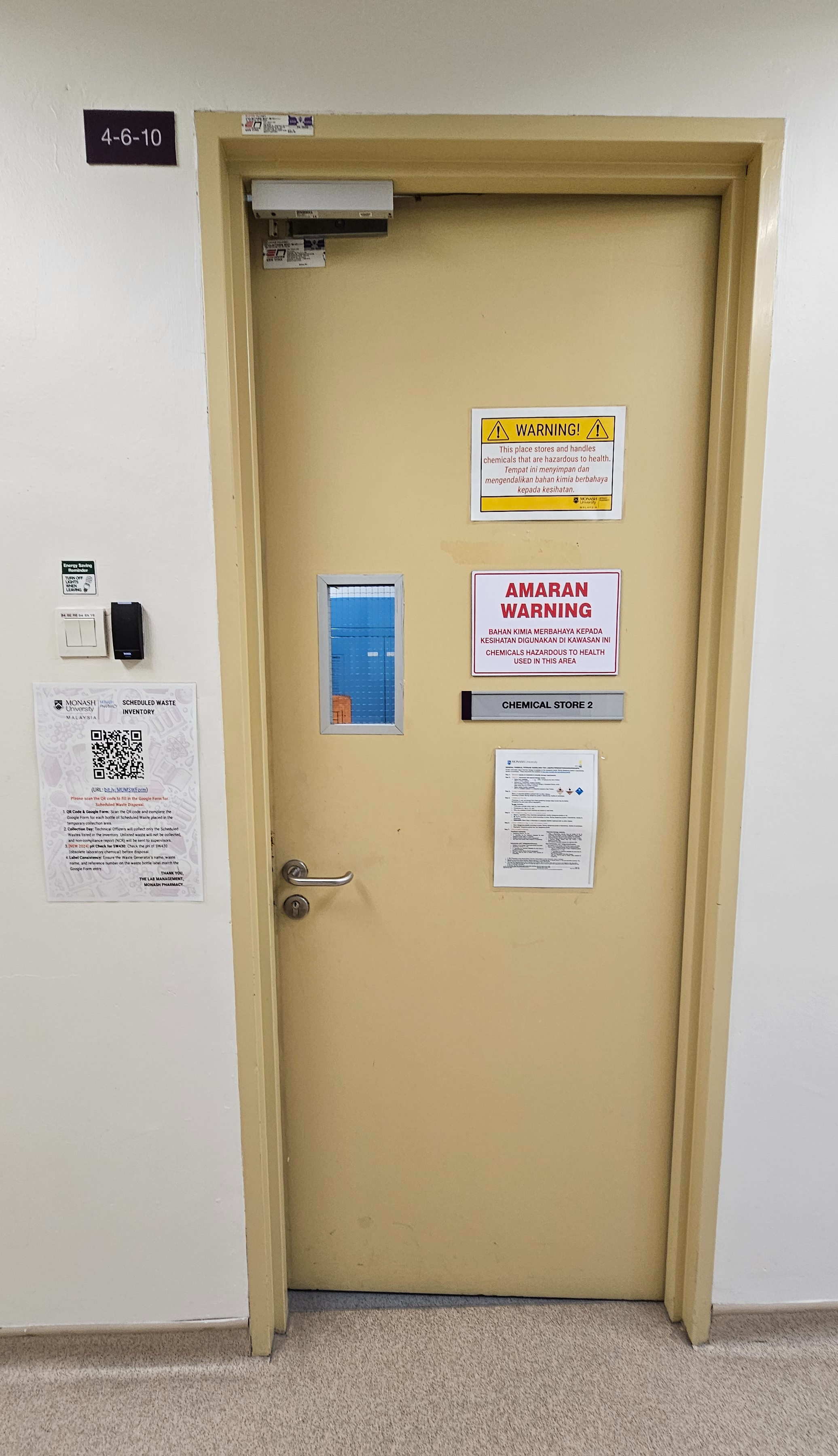 Door of room 4-6-10 signed Chemical Store 2, with hazardous chemical warning signs in English and Malay, card access, and the scheduled waste inventory QR poster on the wall beside it